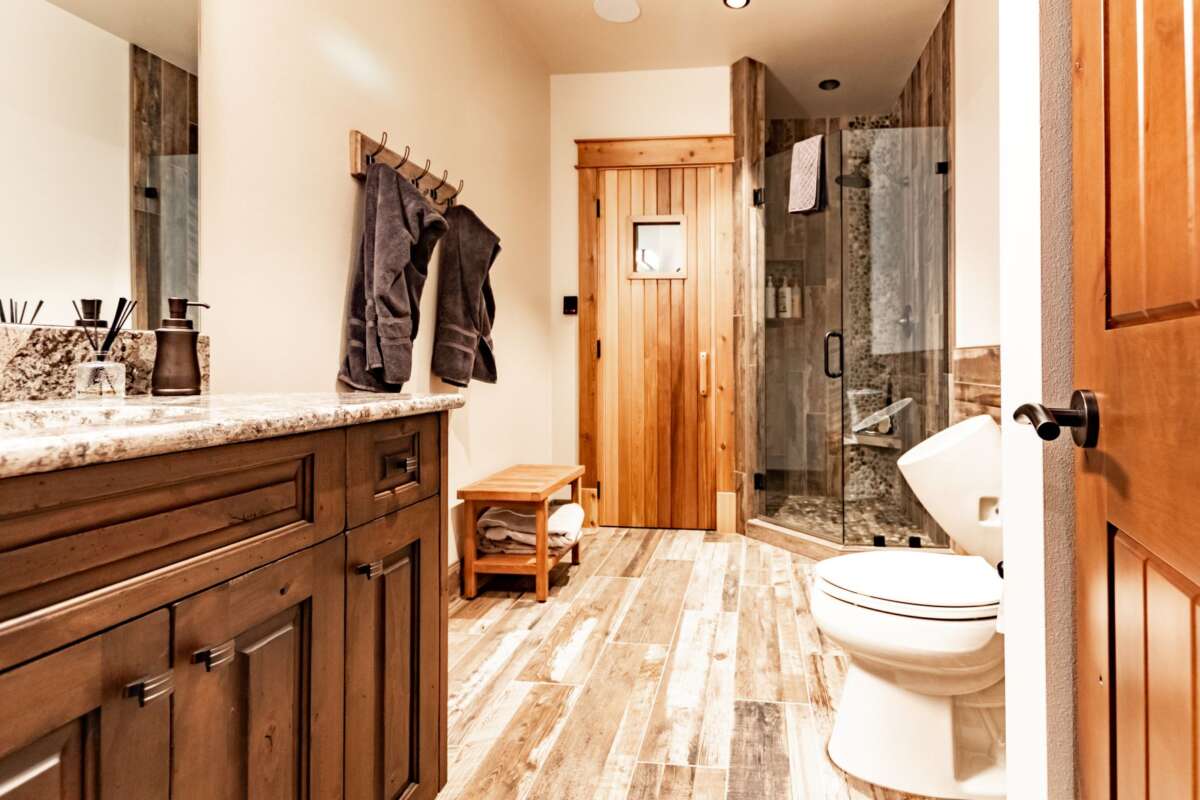 bathroom with wood door to sauna and countertop