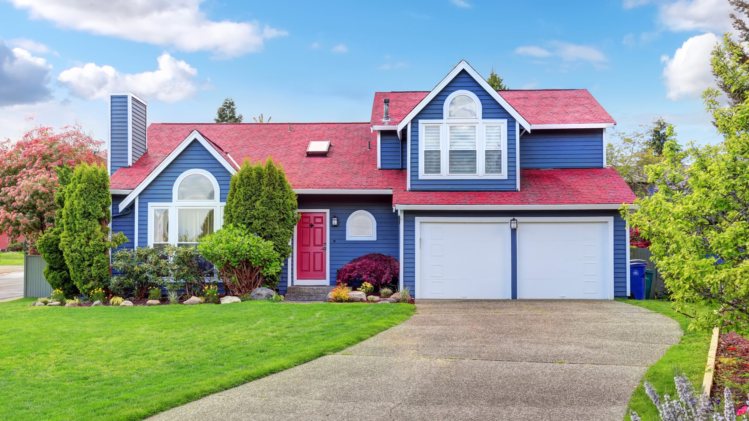 Beautiful home with blue colored siding and red colored roof and door