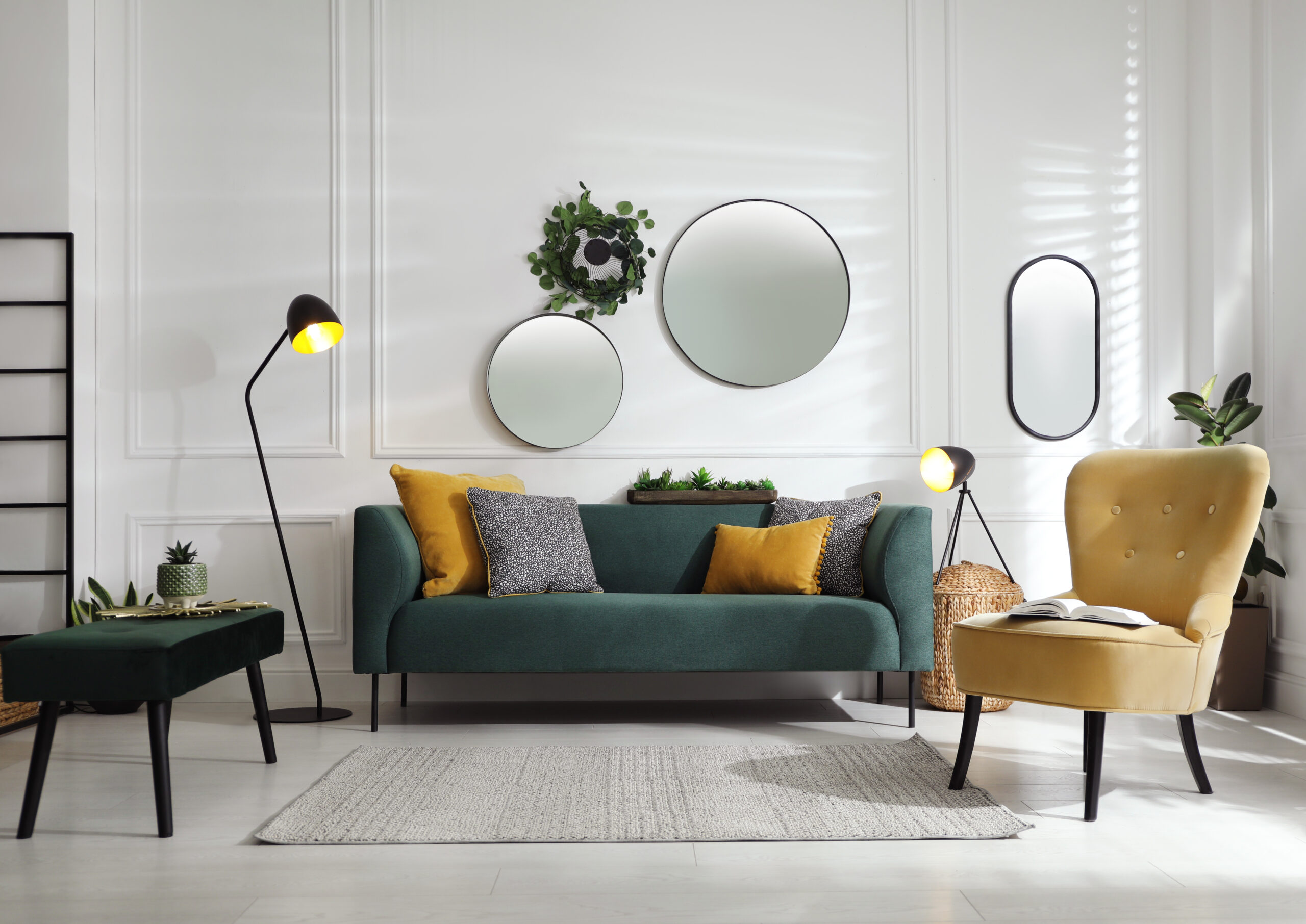 Modern living room with white walls, mirrors, and furniture