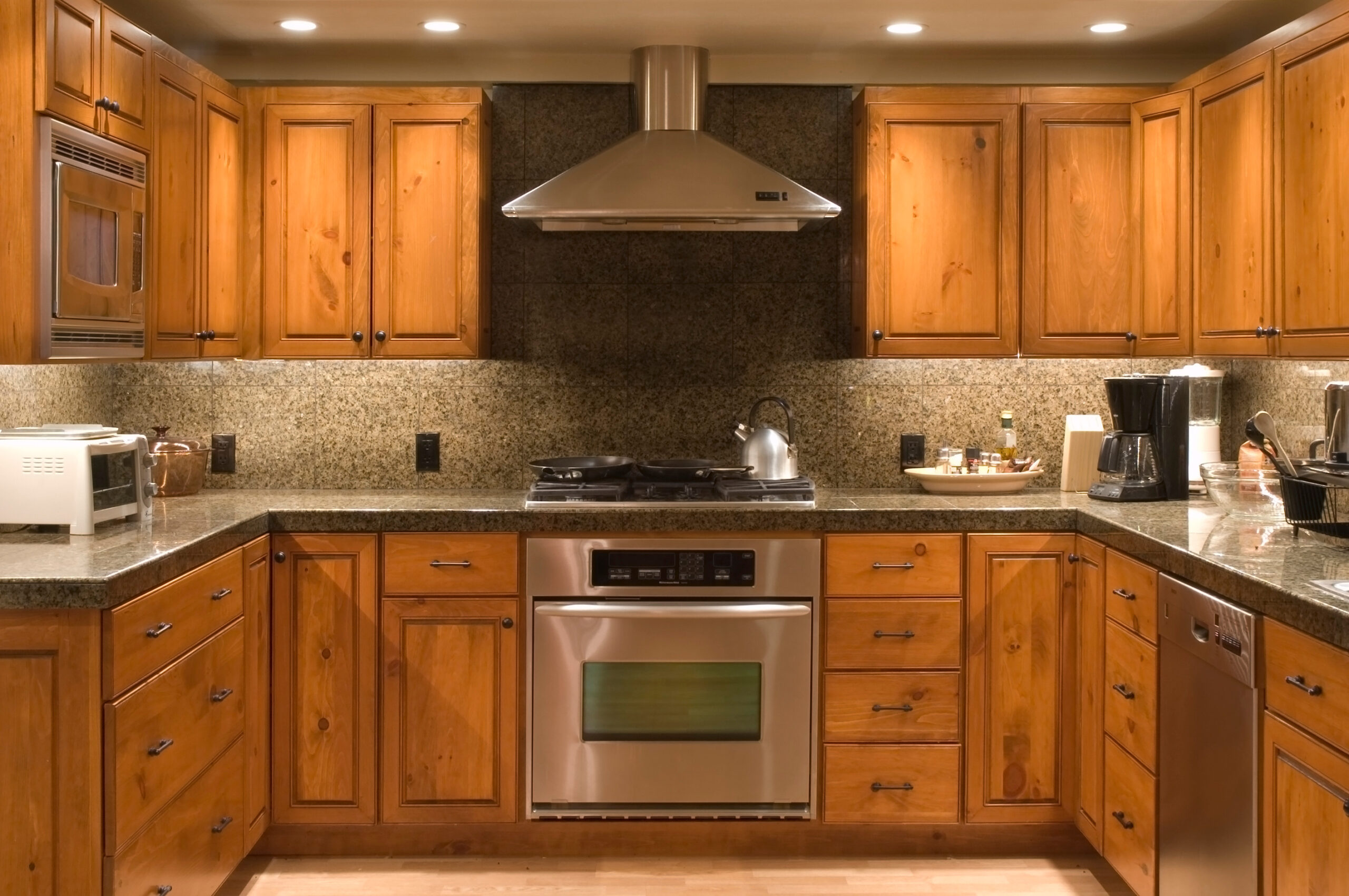 Newly-painted wood kitchen cabinets around a modern stove