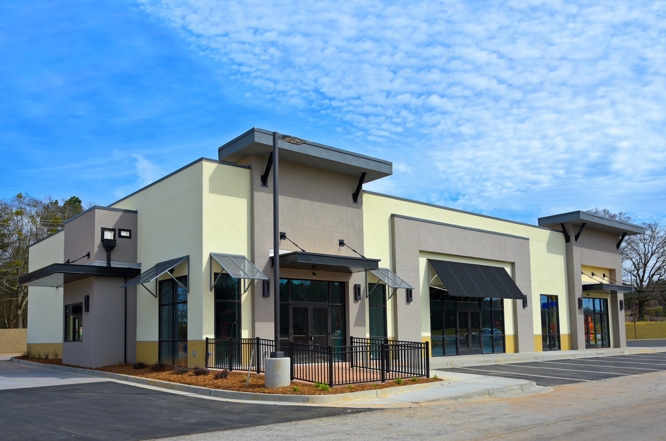 Tan storefronts with black awning