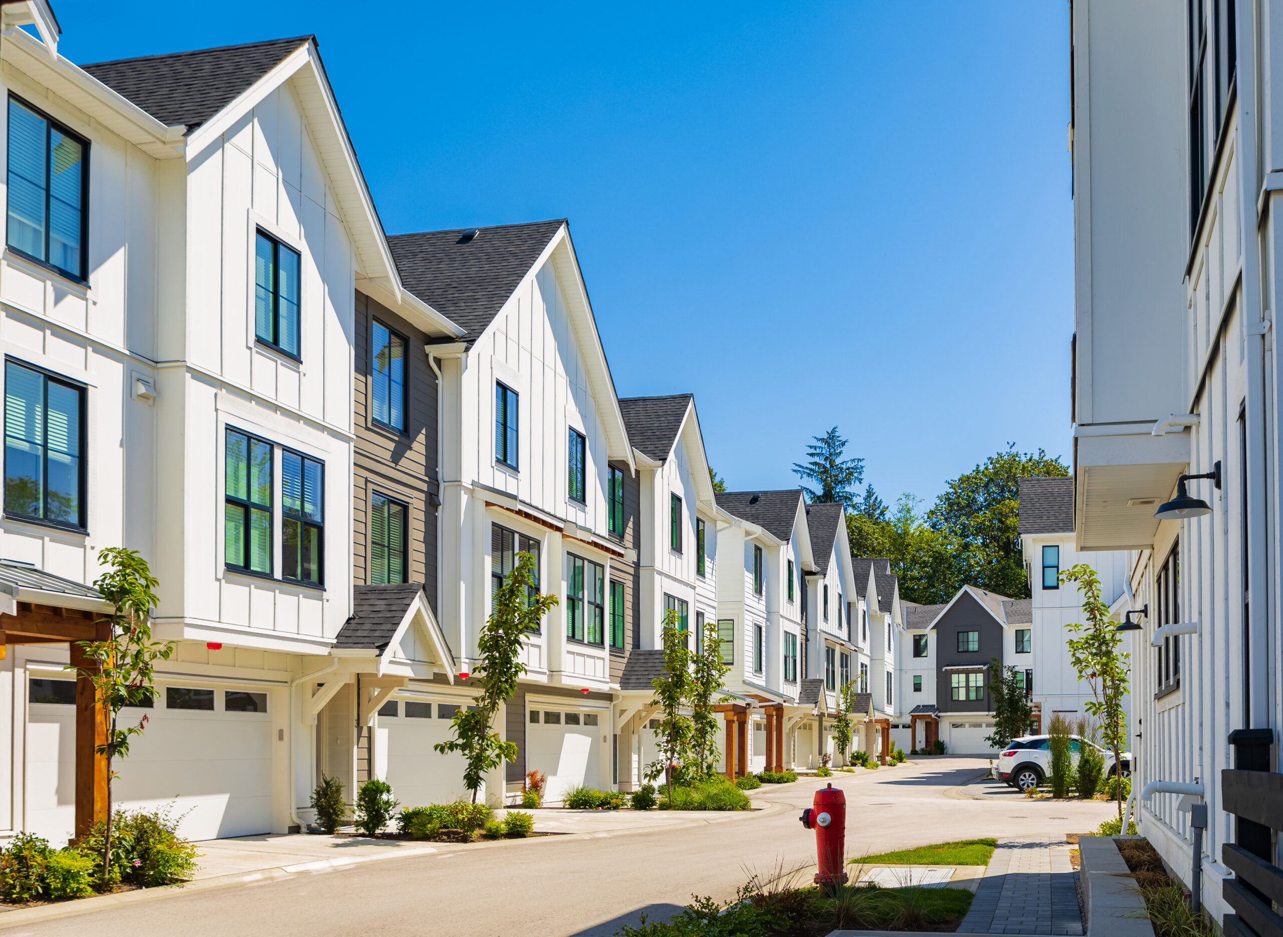 Line of white two-story townhouses