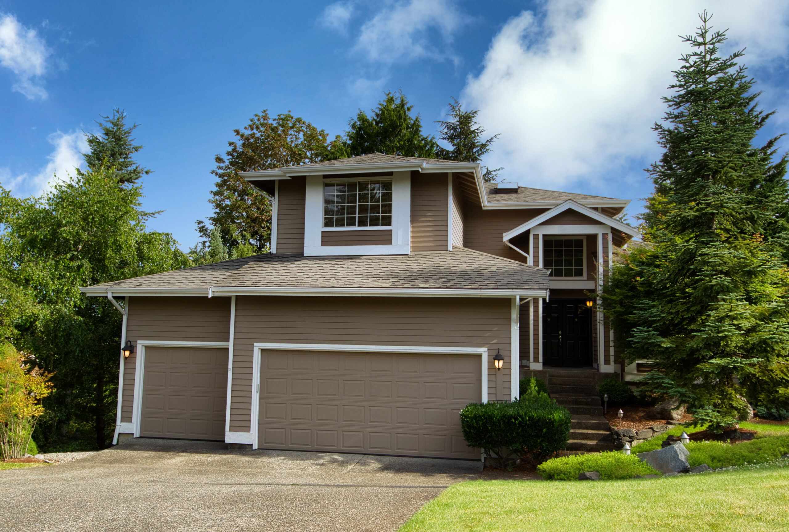 Freshly painted brown home with white features