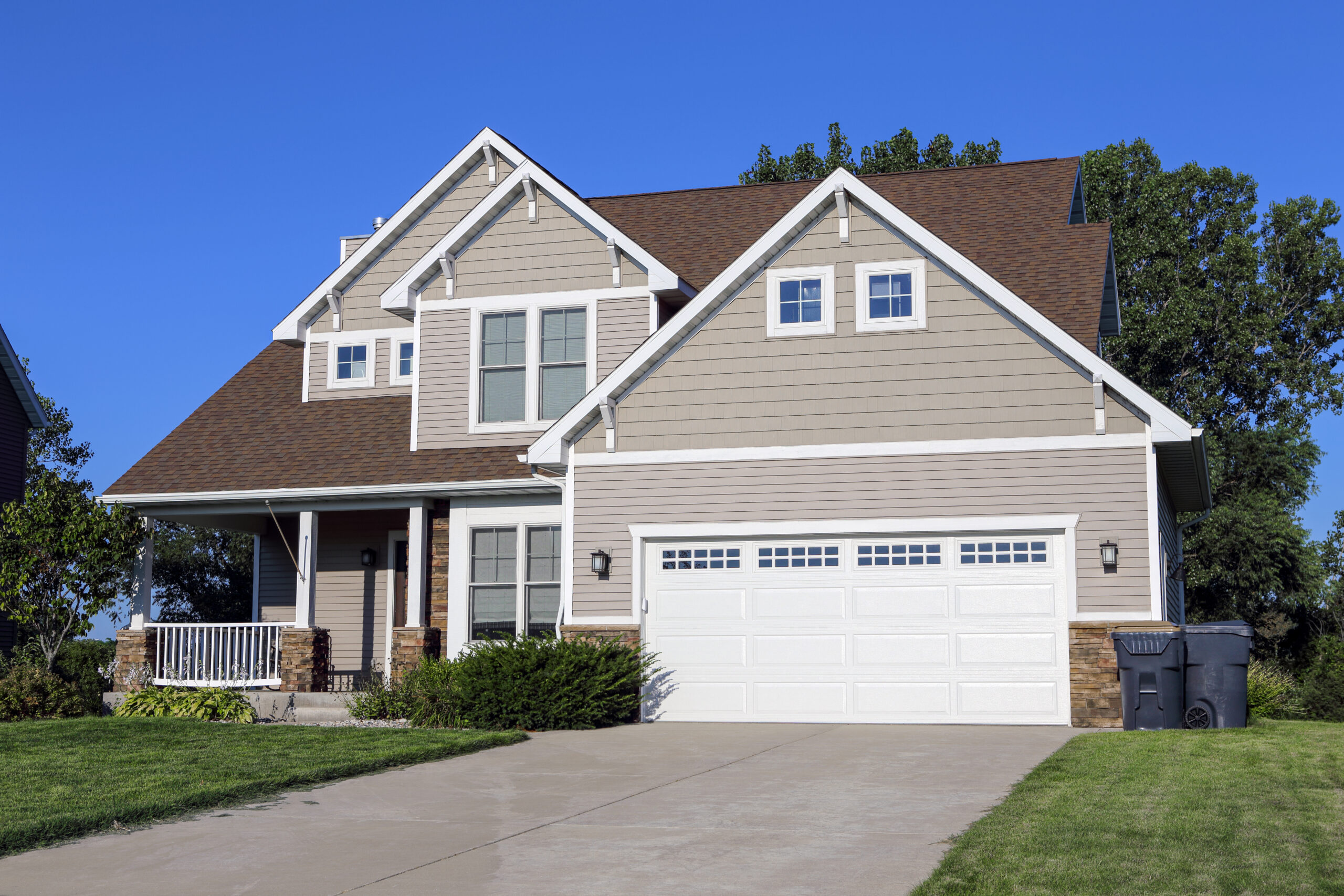 Beige house with a white garage