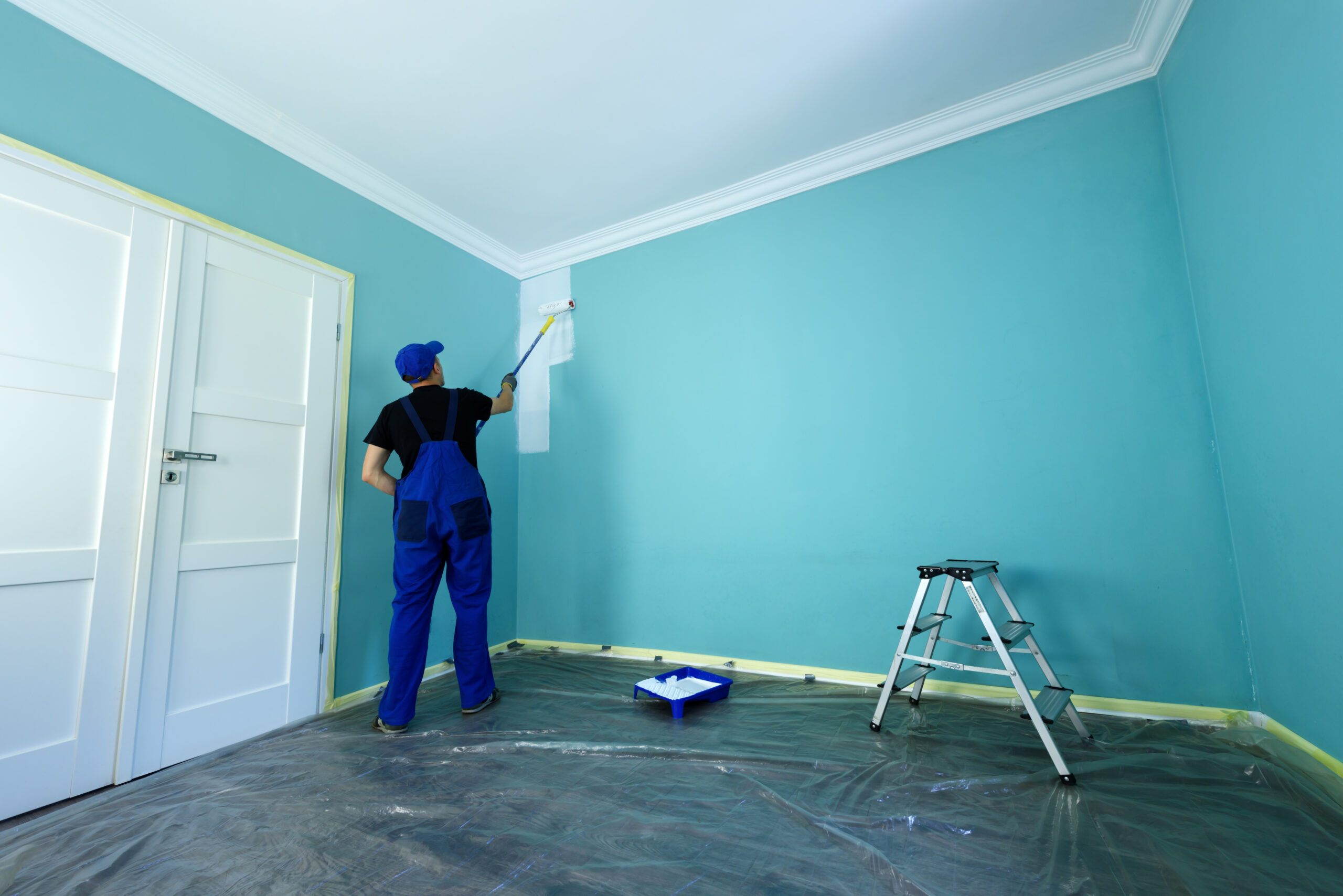 Interior painter painting a wall